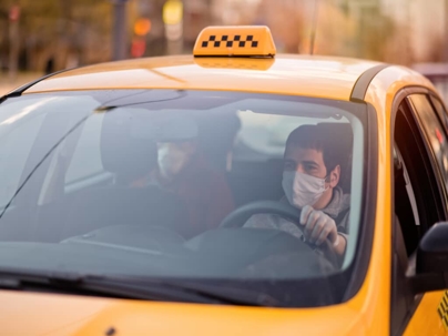 a taxi driver wearing a mask